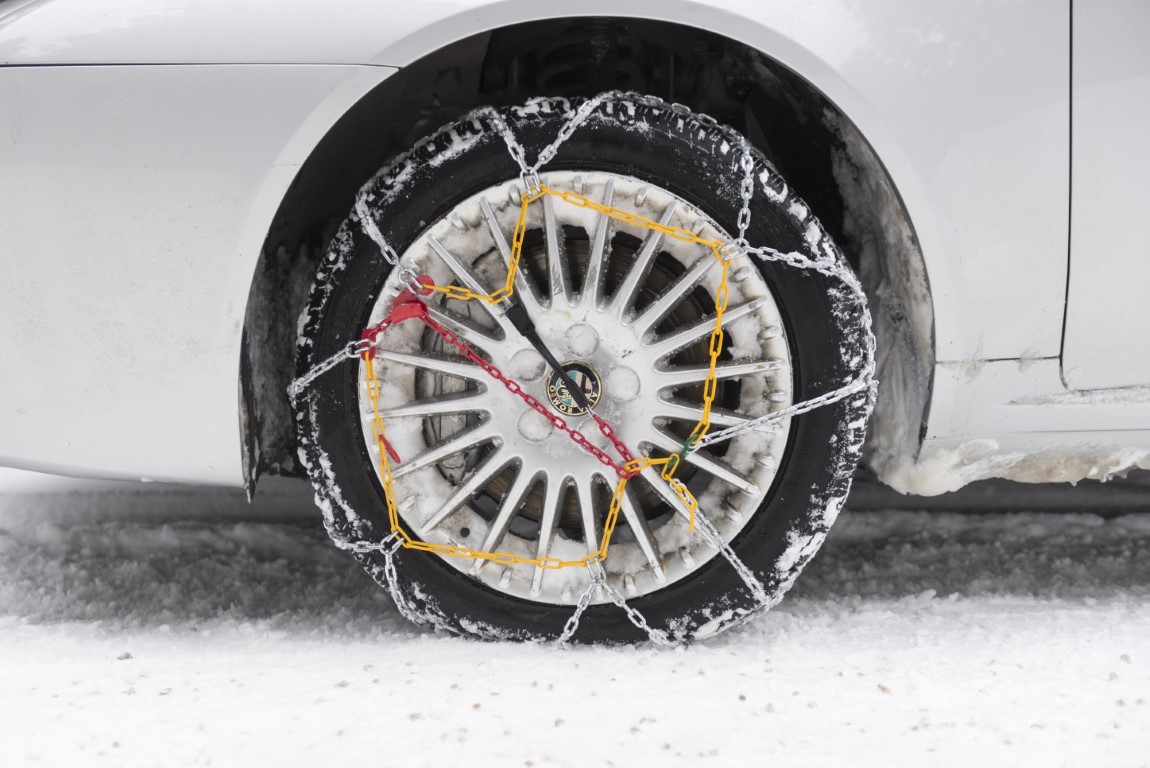 car tyre with winter chains. tire snow chains